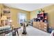 This bedroom has yellow walls, a window, and shelves at 306 Brandywine Dr, Valrico, FL 33594