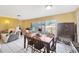 Open dining area featuring tile floors, a wooden table with chairs, and natural light from sliding glass doors at 306 Brandywine Dr, Valrico, FL 33594