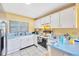 Well-lit kitchen featuring ample counter space, white cabinets, and modern appliances at 306 Brandywine Dr, Valrico, FL 33594