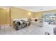 Bright living room featuring tile flooring, with comfortable seating and a sunny window at 306 Brandywine Dr, Valrico, FL 33594
