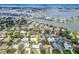 Stunning aerial view showcases this waterfront home nestled among other homes, canals, and open ocean at 308 Cedar Ln, Largo, FL 33770