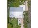 Aerial view showcases the home's unique roof, landscaping, and outdoor living space at 308 Cedar Ln, Largo, FL 33770