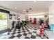 Finished basement featuring retro decor, including checkered flooring, a diner booth, and neon accents at 308 Cedar Ln, Largo, FL 33770