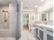 Stylishly designed bathroom with a walk-in shower, marble vanity, and modern fixtures at 308 Cedar Ln, Largo, FL 33770