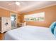Bedroom featuring a bed with blue pillows, built-in storage, a desk, and a connecting bathroom at 308 Cedar Ln, Largo, FL 33770