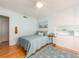 Light blue bedroom featuring a cozy bed, white ceiling fan, and built-in cabinets for ample storage at 308 Cedar Ln, Largo, FL 33770