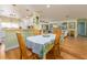Bright dining room with hardwood floors, table with six chairs and lots of natural light at 308 Cedar Ln, Largo, FL 33770