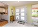 Bright foyer with tile flooring, decorative chest, and a view into the kitchen provides a warm welcome at 308 Cedar Ln, Largo, FL 33770