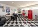 Retro game room with diner-style seating, vintage jukebox, popcorn machine, and checkered flooring at 308 Cedar Ln, Largo, FL 33770