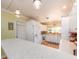 Well-lit kitchen features white cabinetry, stainless steel appliances, and large counter space at 308 Cedar Ln, Largo, FL 33770