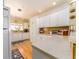 Bright kitchen with white cabinetry, granite countertops, and stainless appliances at 308 Cedar Ln, Largo, FL 33770