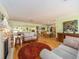 Open-concept living room flows seamlessly into the dining area, offering ample space for entertaining and relaxation at 308 Cedar Ln, Largo, FL 33770