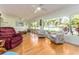 Spacious living room with hardwood floors, large windows, and comfortable seating at 308 Cedar Ln, Largo, FL 33770