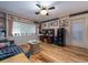 Cozy living room with hardwood floors, built-in shelves, and a unique glass block window at 308 Cedar Ln, Largo, FL 33770