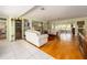 Spacious living room with hardwood floors, fireplace, and built-in shelving showcases an inviting living space at 308 Cedar Ln, Largo, FL 33770
