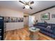Inviting living room features a comfortable plaid couch, hardwood floors, and lots of built-in storage at 308 Cedar Ln, Largo, FL 33770
