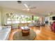 Inviting living room with hardwood floors, ceiling fan, and abundant natural light at 308 Cedar Ln, Largo, FL 33770