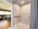Modern walk-in shower featuring stylish tile work and convenient grab bars for accessibility at 308 Cedar Ln, Largo, FL 33770