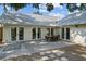 Neutral brick patio with dining table and umbrella, accessed via three sets of French doors, provides outdoor living space at 3315 W Hawthorne Rd, Tampa, FL 33611