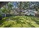 Expansive backyard with mature trees and a swing at 3315 W Hawthorne Rd, Tampa, FL 33611
