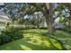Lush backyard with artificial turf and shady trees at 3315 W Hawthorne Rd, Tampa, FL 33611