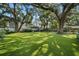 Spacious backyard with green turf and mature trees at 3315 W Hawthorne Rd, Tampa, FL 33611
