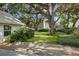 Backyard with lush green turf and mature trees at 3315 W Hawthorne Rd, Tampa, FL 33611