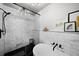 Bright bathroom with a marble-tiled walk-in shower, half-wall, soaking tub, and matte black fixtures at 3315 W Hawthorne Rd, Tampa, FL 33611