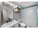 Bathroom featuring a toilet, vanity, and shower/tub combination with decorative curtain at 3315 W Hawthorne Rd, Tampa, FL 33611