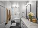 Modern bathroom with a marble-tiled tub, glass shower, double vanity, and black fixtures at 3315 W Hawthorne Rd, Tampa, FL 33611