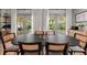Dining area featuring a large table, stylish chairs, and access to outdoor patio through glass doors at 3315 W Hawthorne Rd, Tampa, FL 33611
