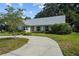 Charming home with a well-manicured lawn, beautiful landscaping, and a curved driveway leading to the front entrance at 3315 W Hawthorne Rd, Tampa, FL 33611
