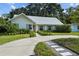 Charming home with lush front yard and sidewalk composed of pavers and pea gravel leading to the front door at 3315 W Hawthorne Rd, Tampa, FL 33611