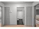 Hallway with views into a bathroom and living space, flanked by two louvered closets at 3315 W Hawthorne Rd, Tampa, FL 33611
