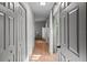 Hallway with light wood floors, neutral walls, and access to various rooms at 3315 W Hawthorne Rd, Tampa, FL 33611