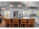 Well-appointed kitchen features a large island, modern appliances, and stylish bar stool seating at 3315 W Hawthorne Rd, Tampa, FL 33611
