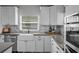 Well-appointed kitchen featuring a farmhouse sink, gray countertops, and modern cabinetry at 3315 W Hawthorne Rd, Tampa, FL 33611