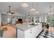 Spacious kitchen island with cooktop and dining area, open to the living space with ample seating at 3315 W Hawthorne Rd, Tampa, FL 33611