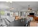 Open-concept living room, kitchen, and dining area featuring modern decor and ample natural light at 3315 W Hawthorne Rd, Tampa, FL 33611