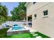 This backyard boasts a refreshing pool, covered patio, and well-manicured lawn for ultimate relaxation at 3503 W Price Ave, Tampa, FL 33611