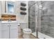 Bathroom features a modern vanity, toilet, and glass-enclosed shower with stylish tilework at 3503 W Price Ave, Tampa, FL 33611