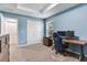 Bedroom with light blue walls, carpet, modern furniture, and a tray ceiling at 3503 W Price Ave, Tampa, FL 33611