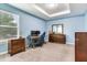 Bedroom featuring light blue walls, carpet, modern furniture, and a tray ceiling at 3503 W Price Ave, Tampa, FL 33611