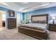 Spacious bedroom with light blue walls, carpet flooring, decorative molding, and wooden bedroom furniture at 3503 W Price Ave, Tampa, FL 33611