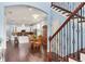 Open-concept dining area with wood floors, flowing into kitchen, with staircase in view at 3503 W Price Ave, Tampa, FL 33611