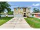 Inviting home with solar panels, a two-car garage, and beautifully landscaped front yard at 3503 W Price Ave, Tampa, FL 33611
