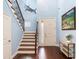 Inviting foyer with staircase, decorative fish art, and hardwood floors at 3503 W Price Ave, Tampa, FL 33611