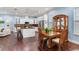 Open concept kitchen and dining area features white cabinets, granite counters, stainless appliances, and a breakfast bar at 3503 W Price Ave, Tampa, FL 33611