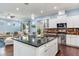 Beautiful kitchen with modern appliances, center island, and a seamless flow to living area at 3503 W Price Ave, Tampa, FL 33611