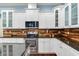Elegant kitchen featuring stainless steel appliances, granite countertops, and white cabinetry at 3503 W Price Ave, Tampa, FL 33611